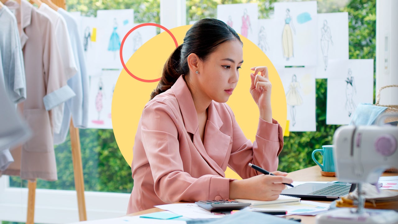 Business owner sits at desk working.