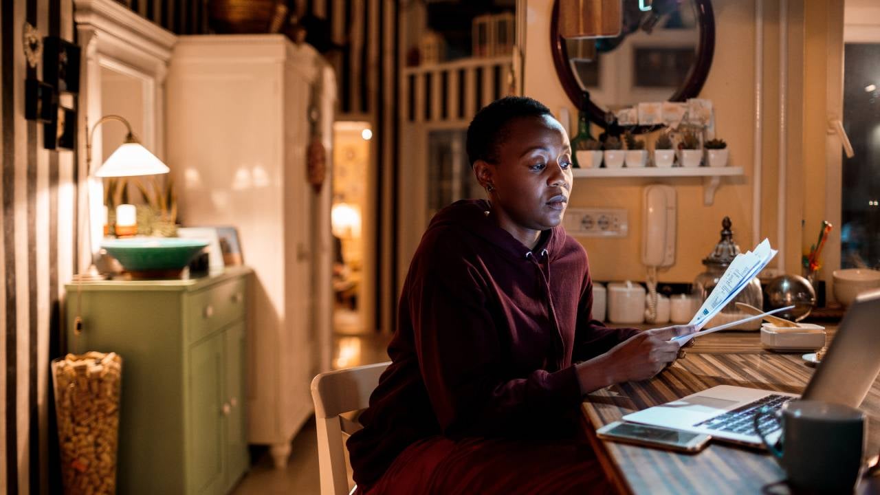 Close up of a young woman doing her home finances in the evening