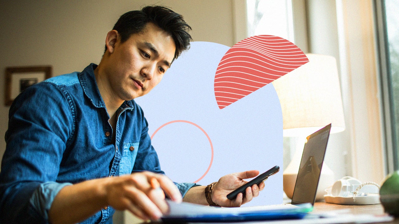 Man working on laptop and cellphone simultaneously