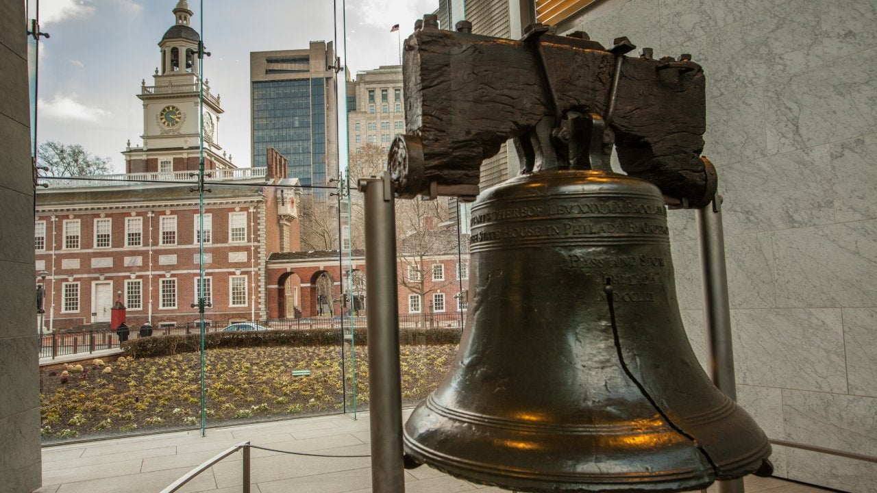 The Liberty Bell and Independence Hall in the back ground at at Philadelphia's Independence National Historic Site.