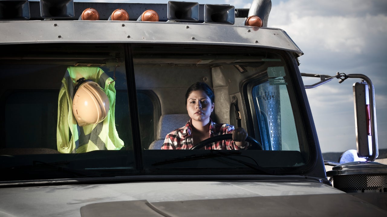 A female truck driver in her semi.