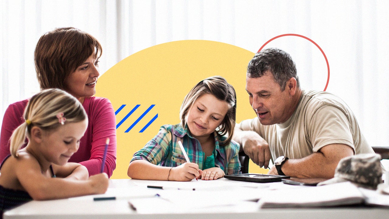 A four person family with children gathered around coloring books