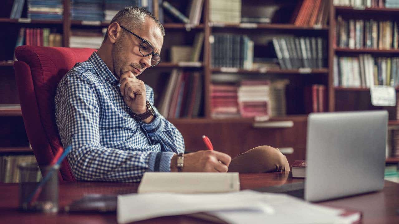 Man taking notes in an office environment