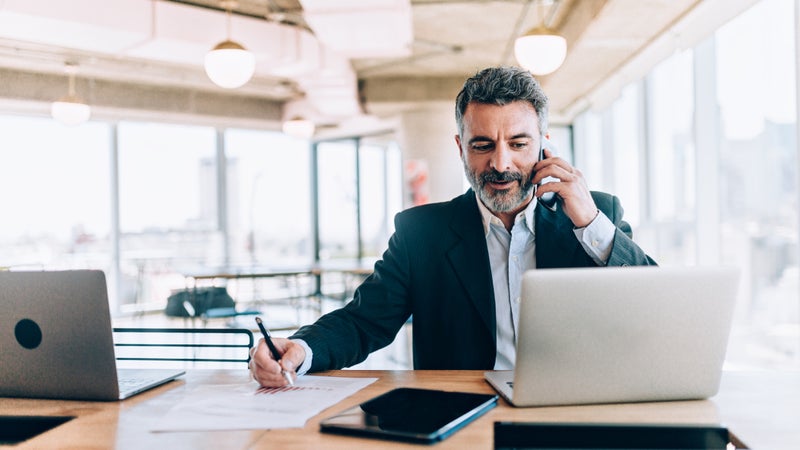 Businessman at the office talking on cell phone