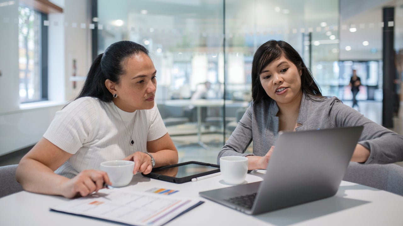 loan manager at laptop meeting with client