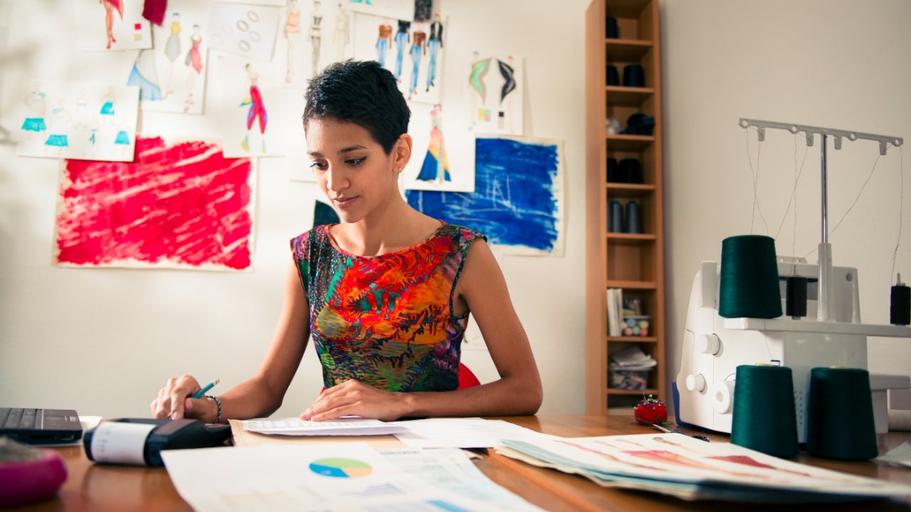 Woman working on a budget and financial documents.