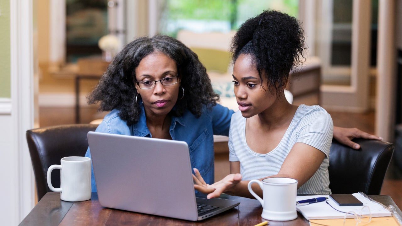 Mature woman helps her daughter study for exam