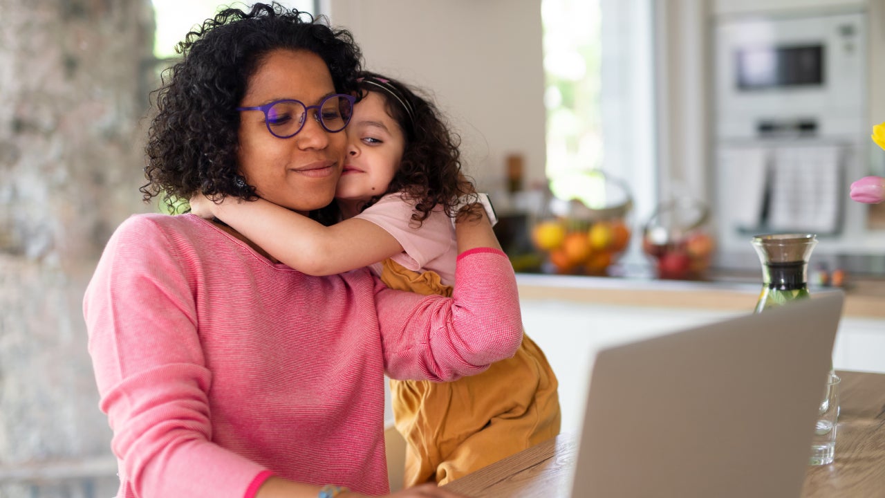 Mother with daughter looking at laptop