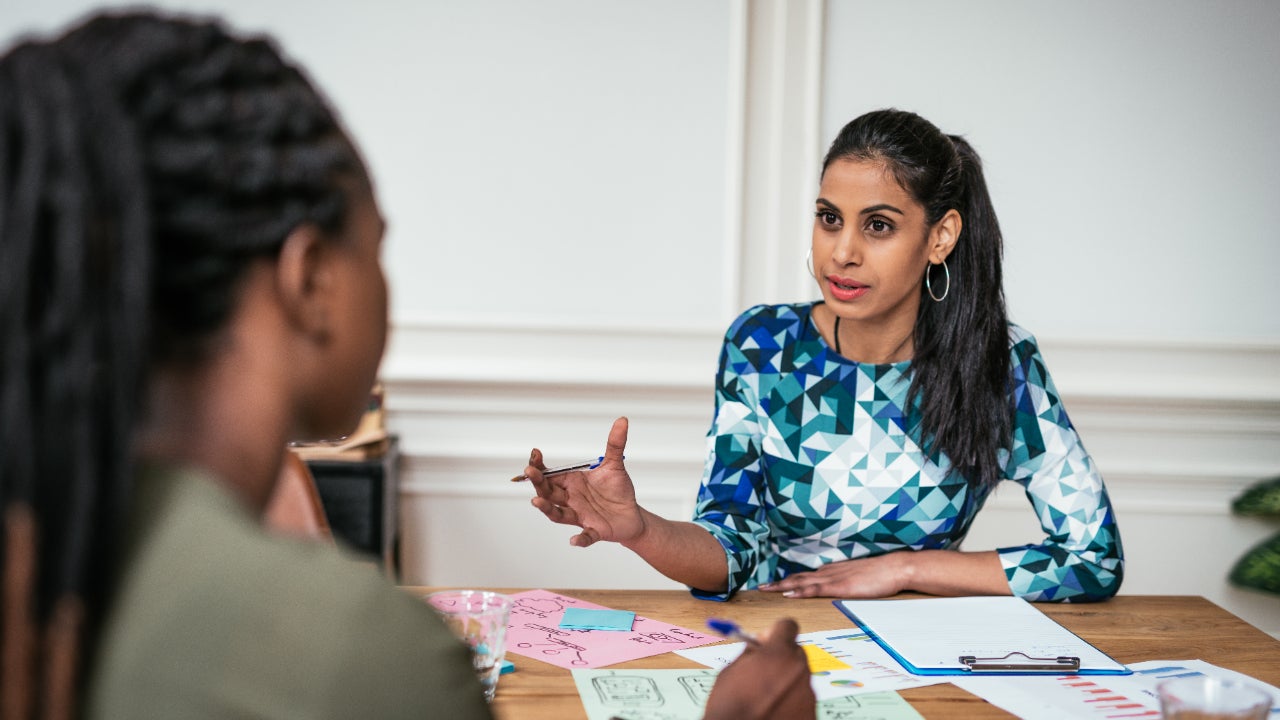 Two women discussing and planning a small business.