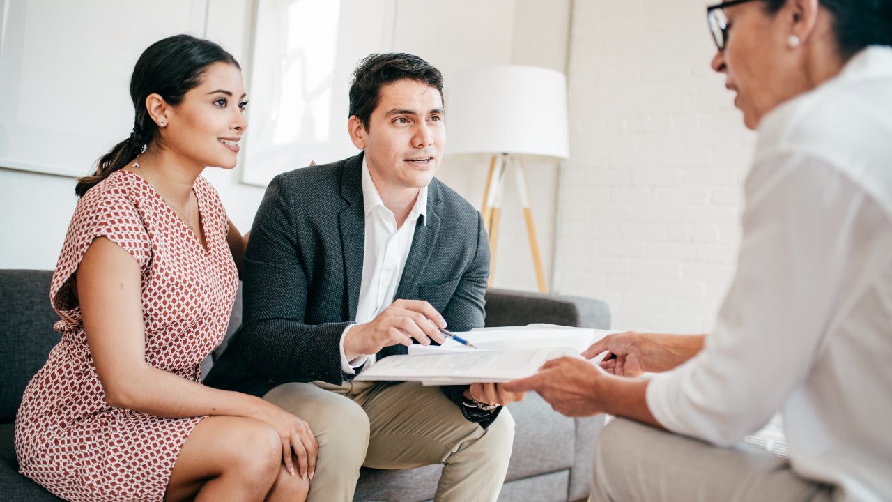 Couple getting financial advice from a female advisor.