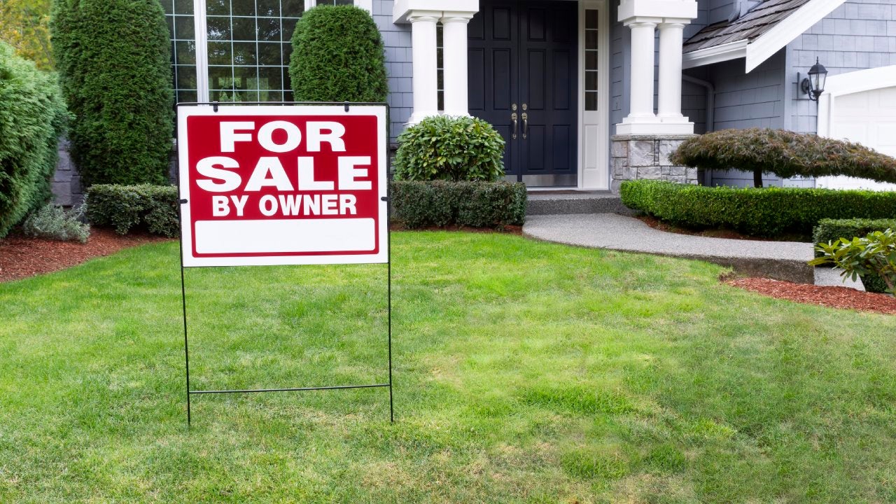 Closeup view of Modern Suburban Home for Sale Real Estate Sign in front of modern home