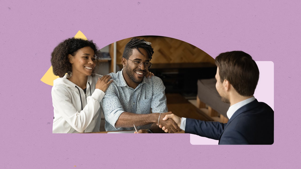 couple shaking hands with business man