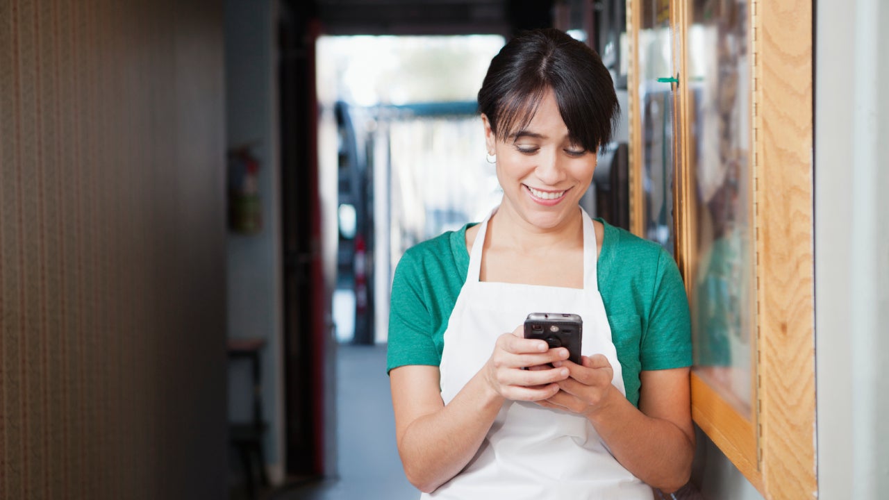 Waitress texting in hallway