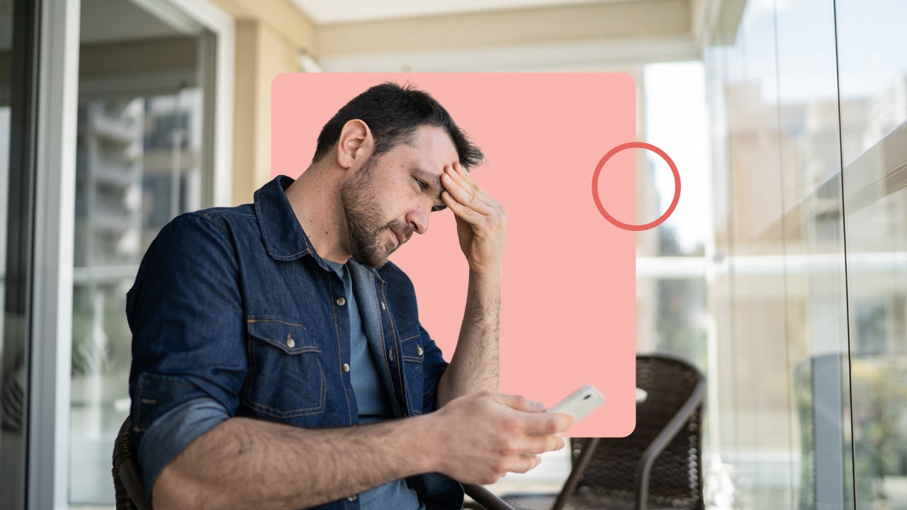 Worried man looking at cellphone