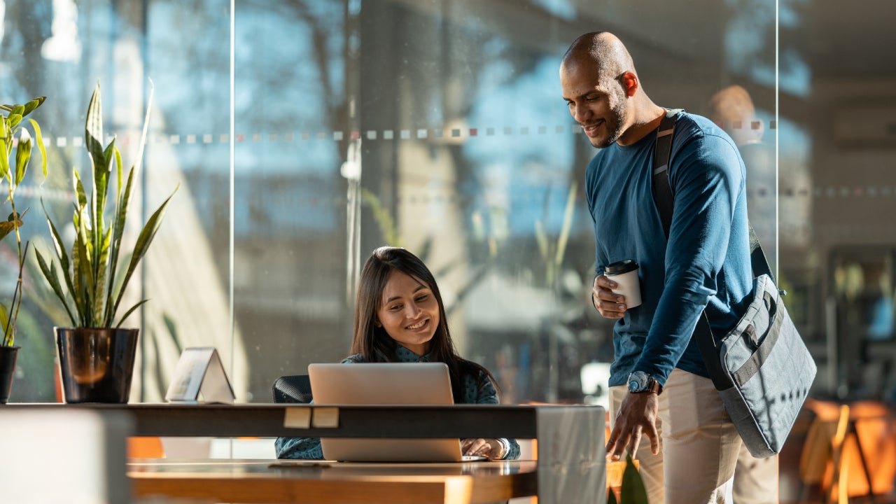 Two coworkers sharing an interaction in a nice office building