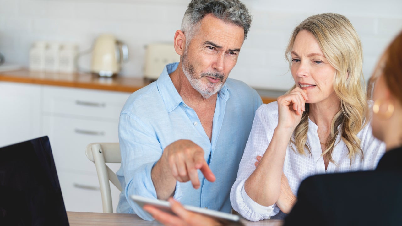 couple meeting investments and financial advisor at home