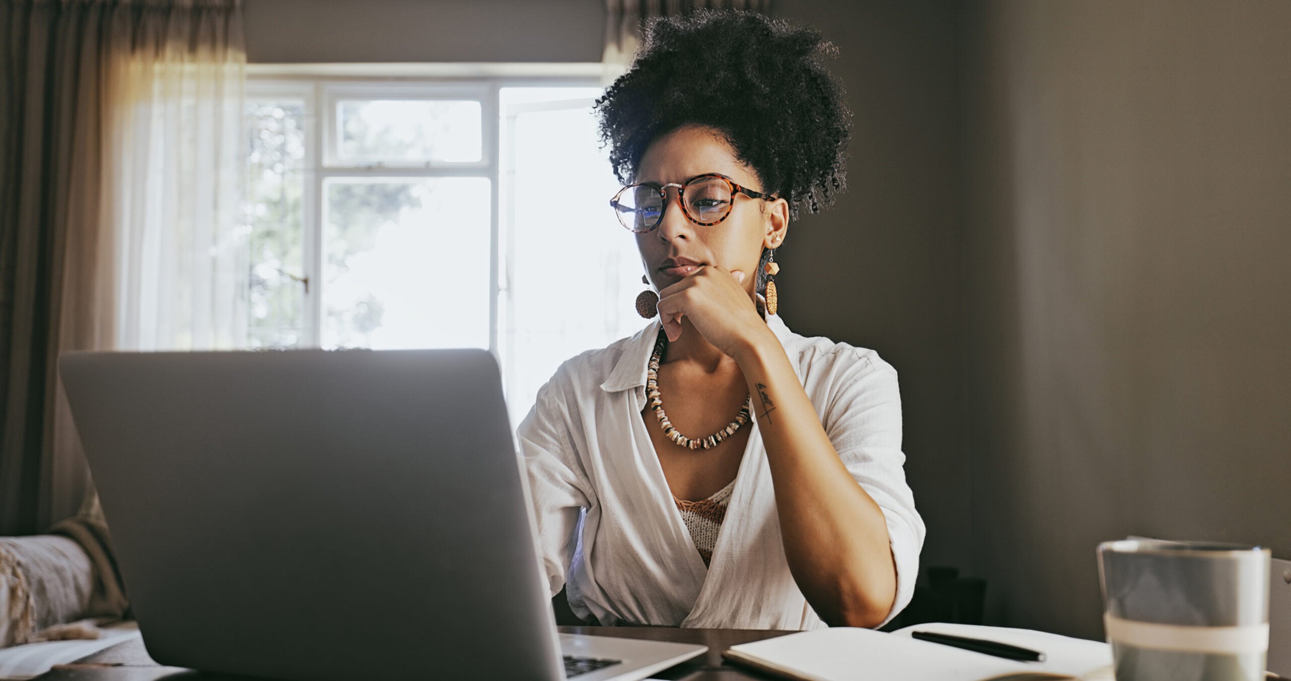 Young woman comparing lenders on laptop