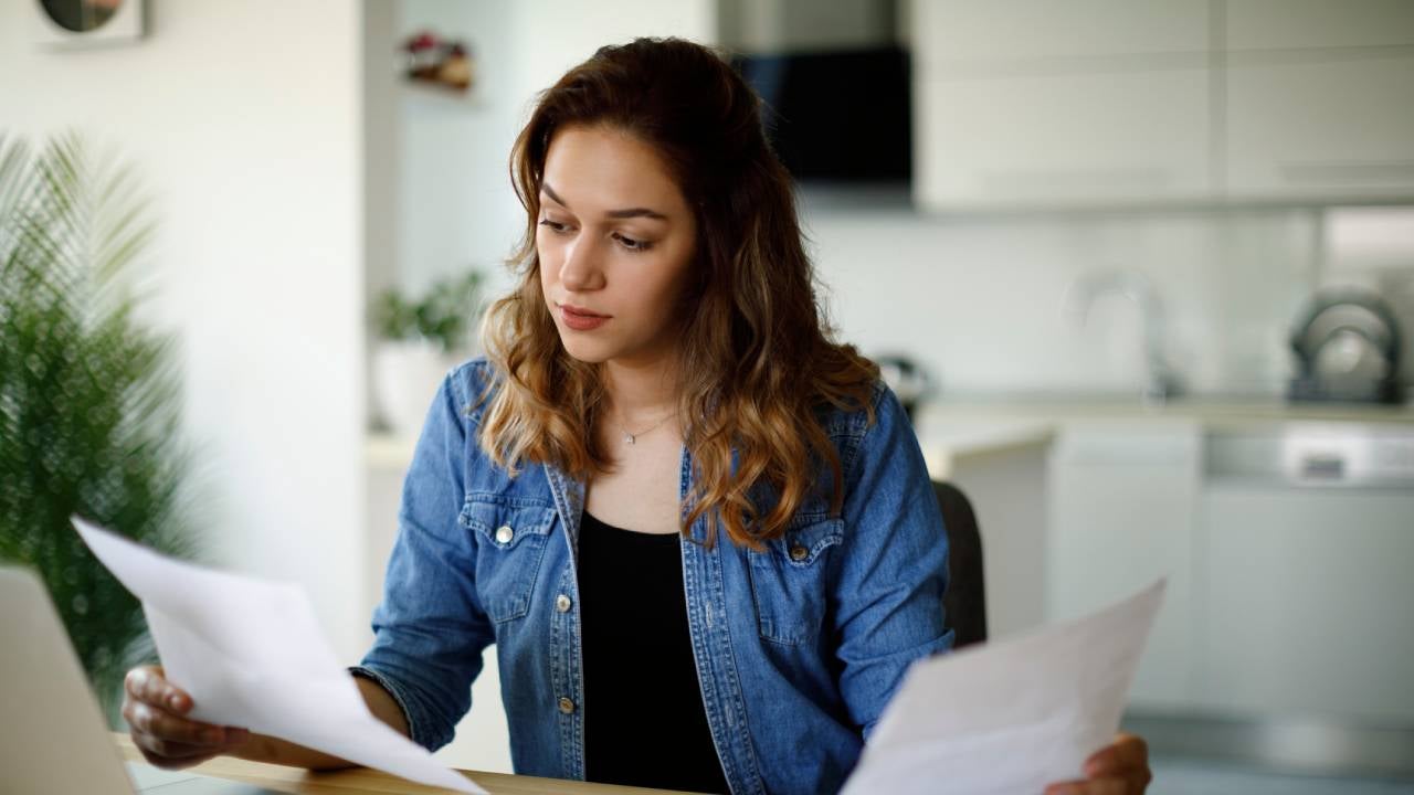 Serious young woman working at home