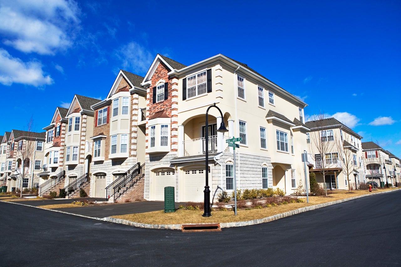 deed restricted property - suburban row houses with blue sky