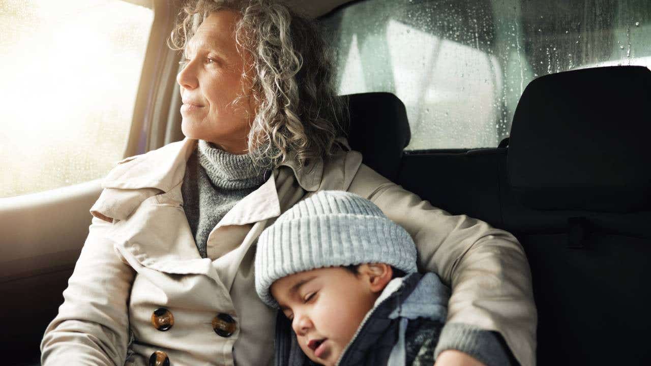 sleeping child and grandma rest on travel adventure for family bonding