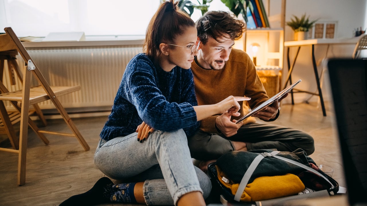 Couple planning vacation trip and searching information on tablet