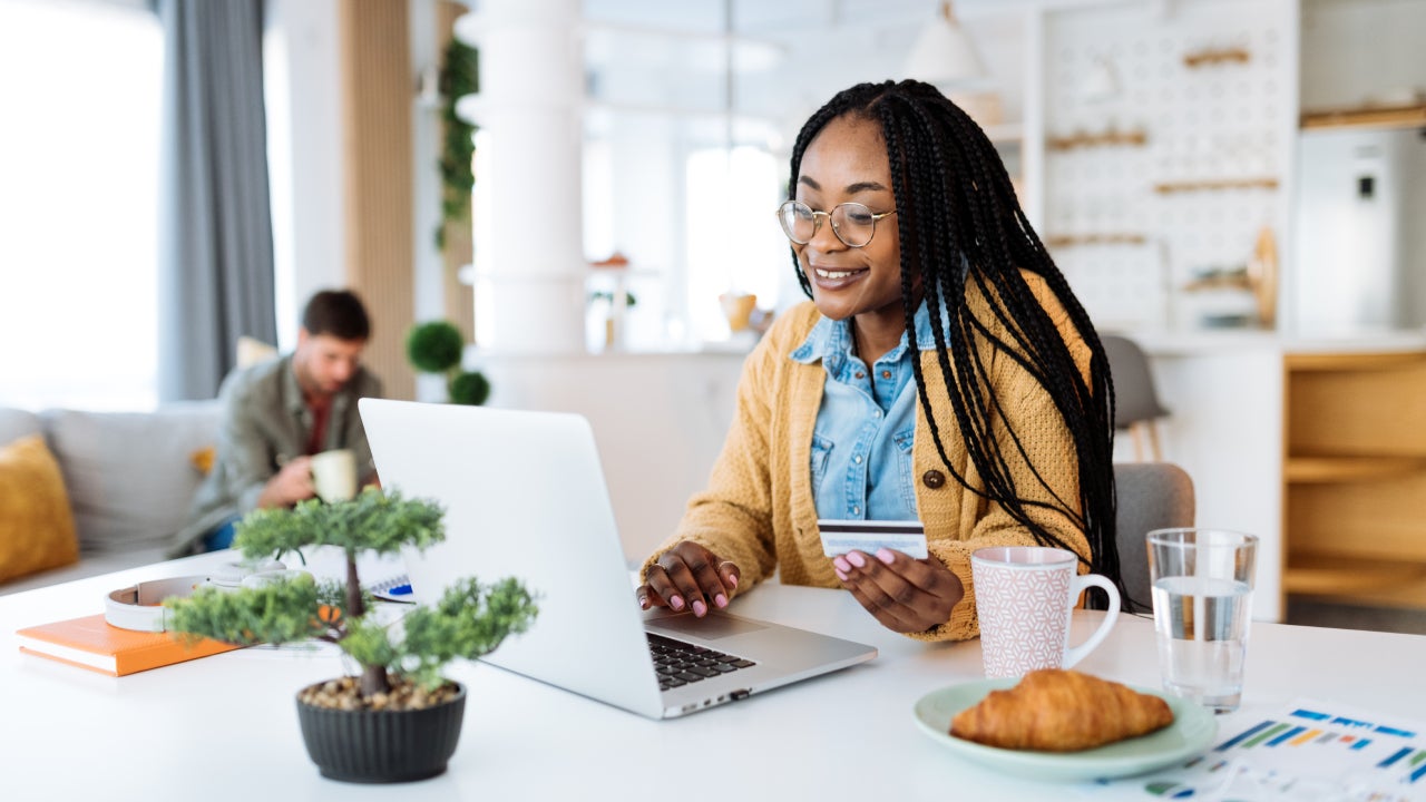 Woman at home, working on laptop