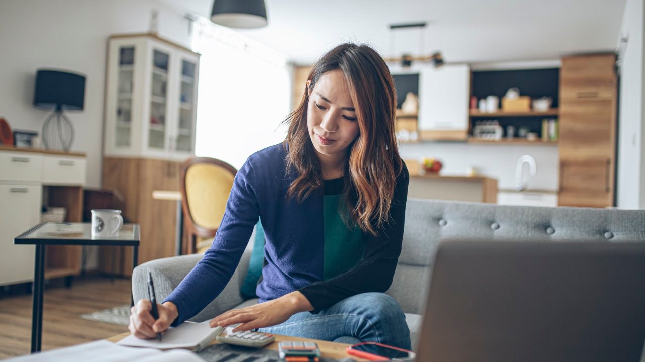 Young woman doing her finances at home