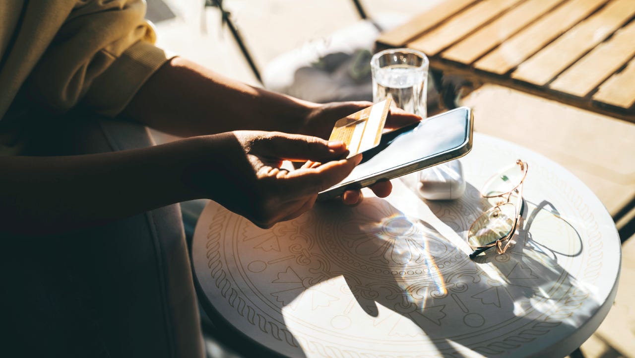 Woman using a credit card to pay online bills using mobile application