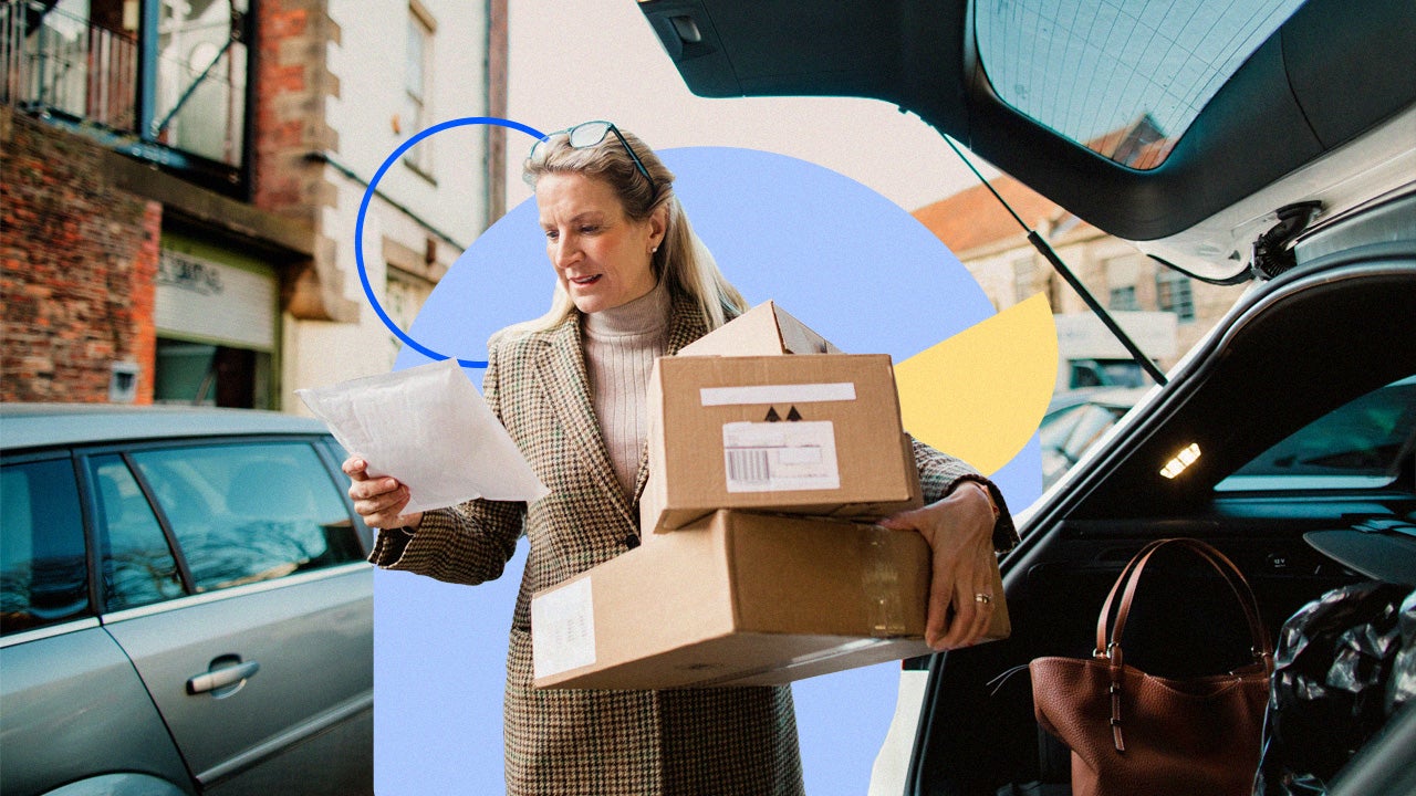 Woman holding boxes and reading a piece of paper