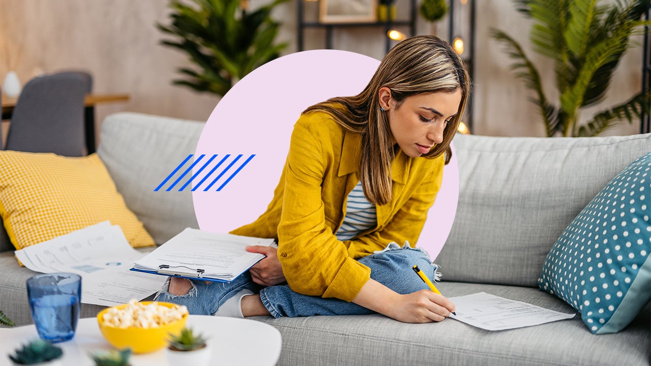 Woman working on paperwork on her couch