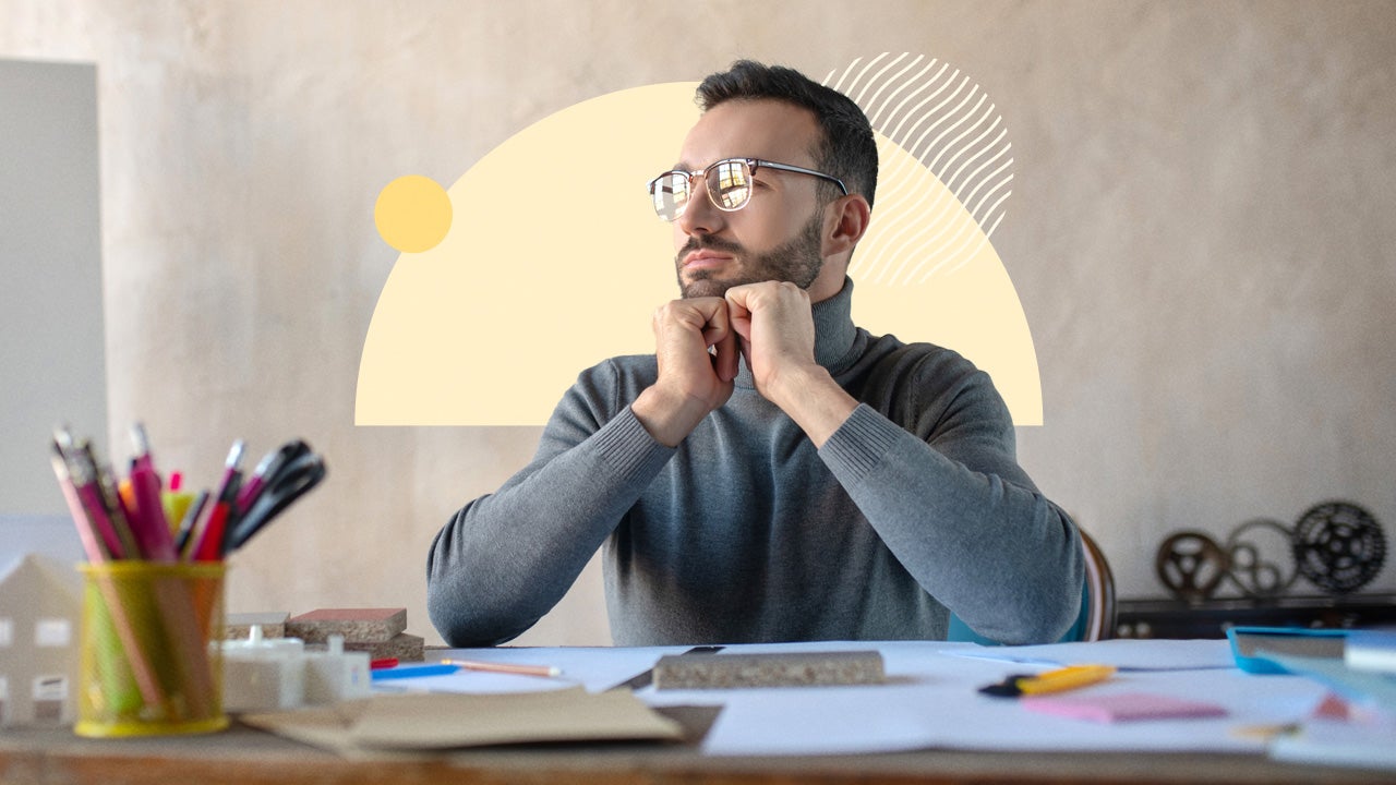 Man with glasses sitting at a desk