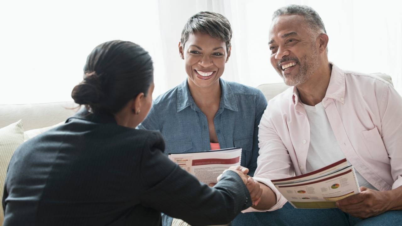 couple talking to businesswoman