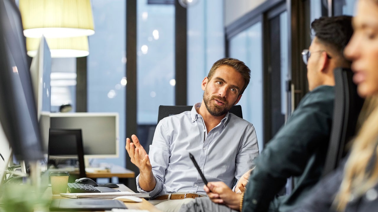 coworkers discussing during meeting in office