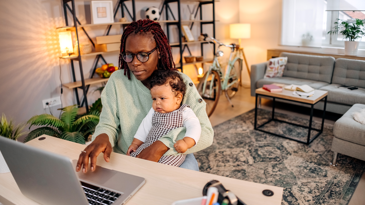 Mother with baby working in office at home