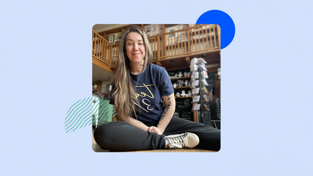 Small business owner Jen McPherson sitting on the floor of her store.