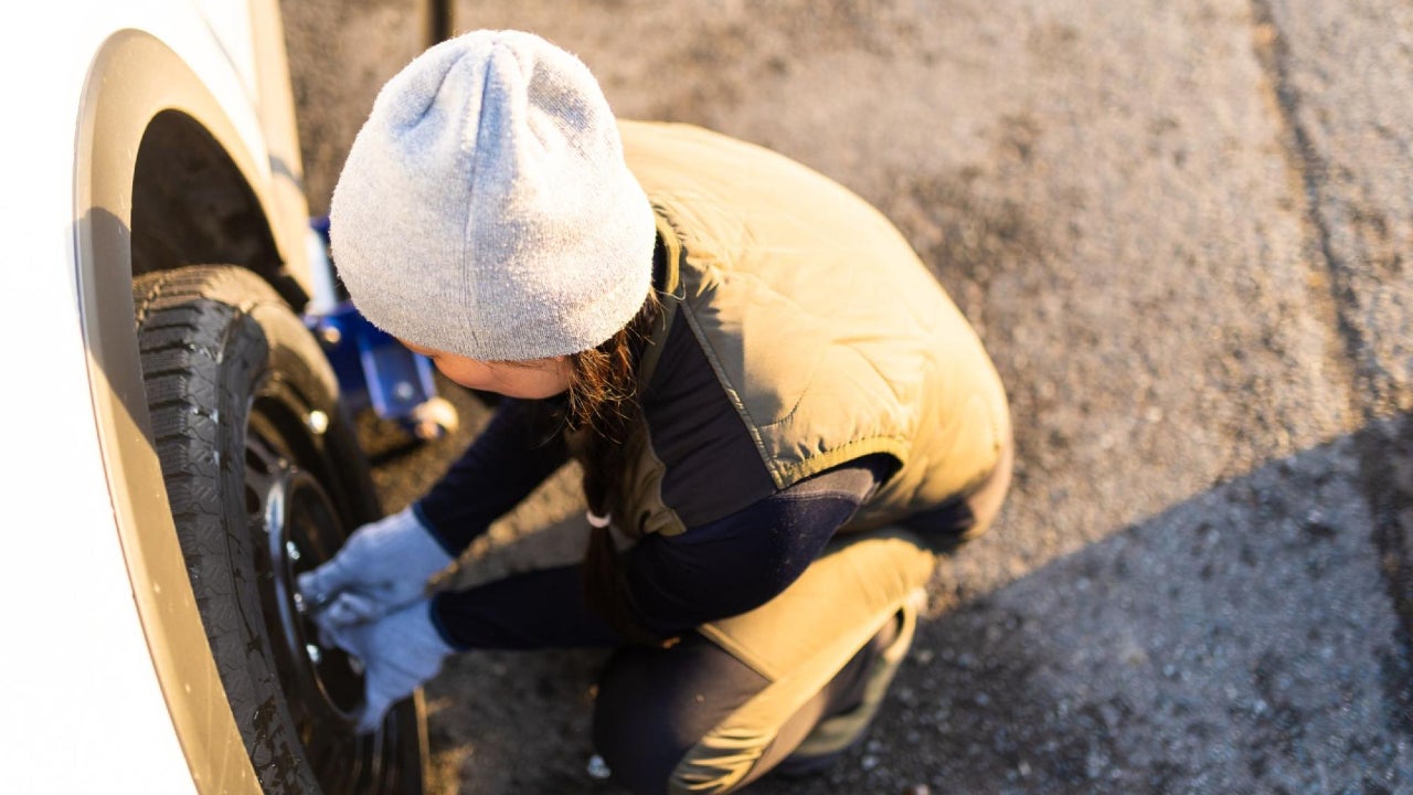 A person changing a tire.