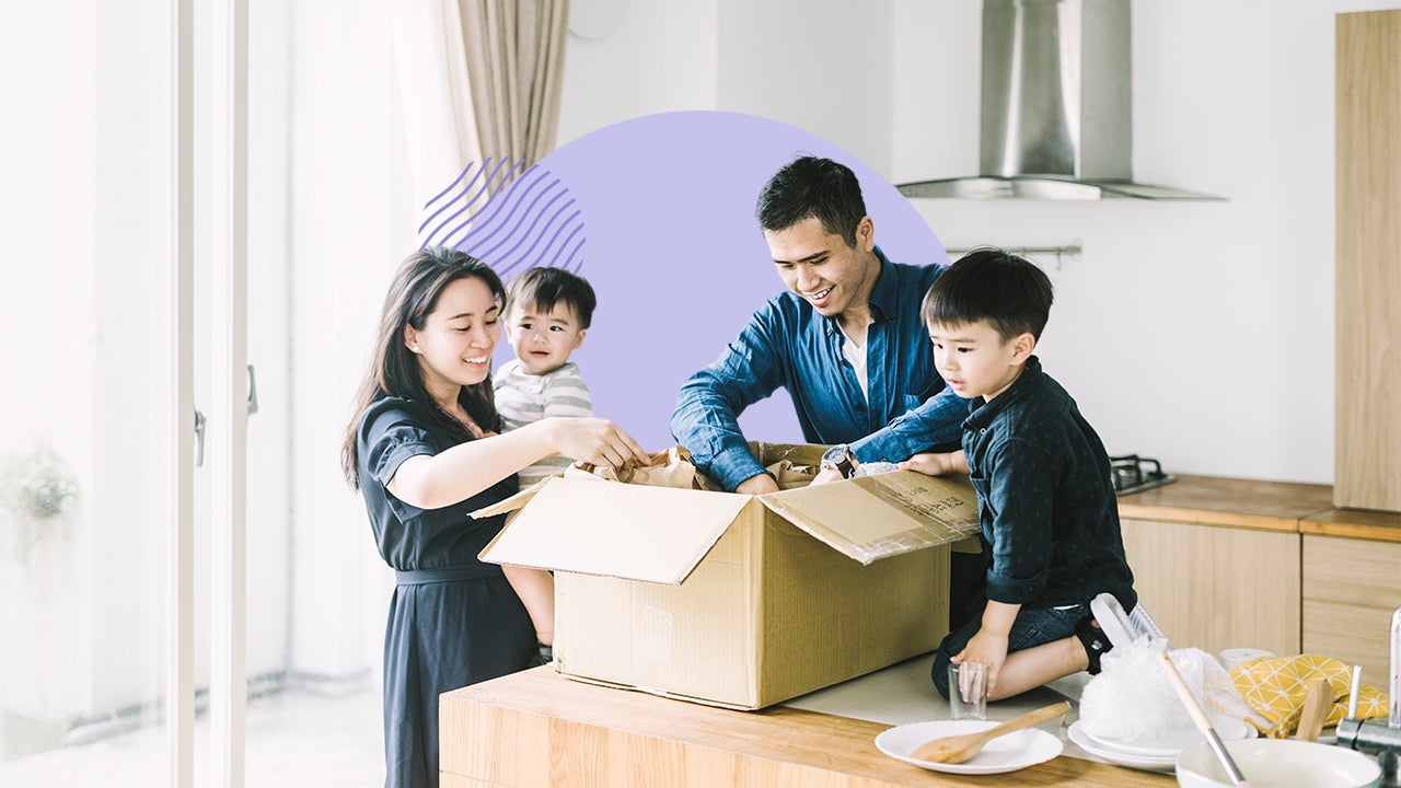 A family unpacking a box together