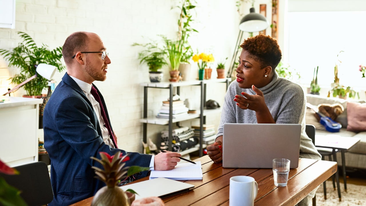 Woman discussing with financial advisor at home