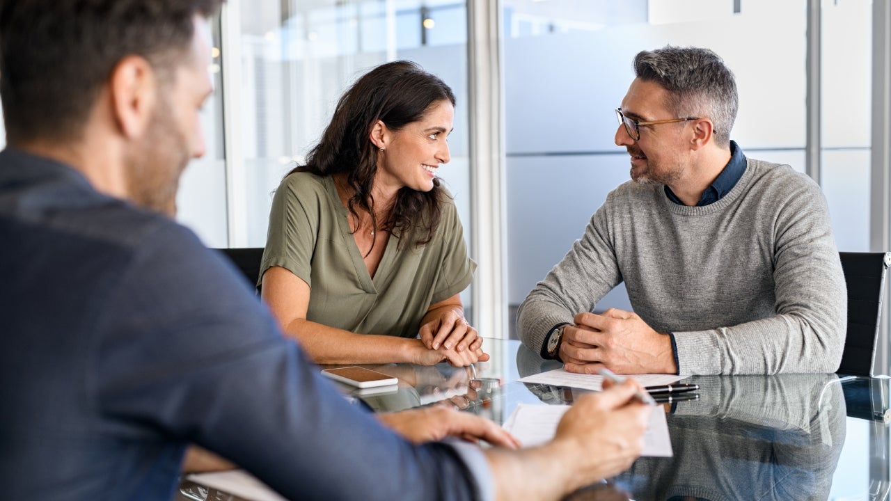 couple consulting bank agent for their savings