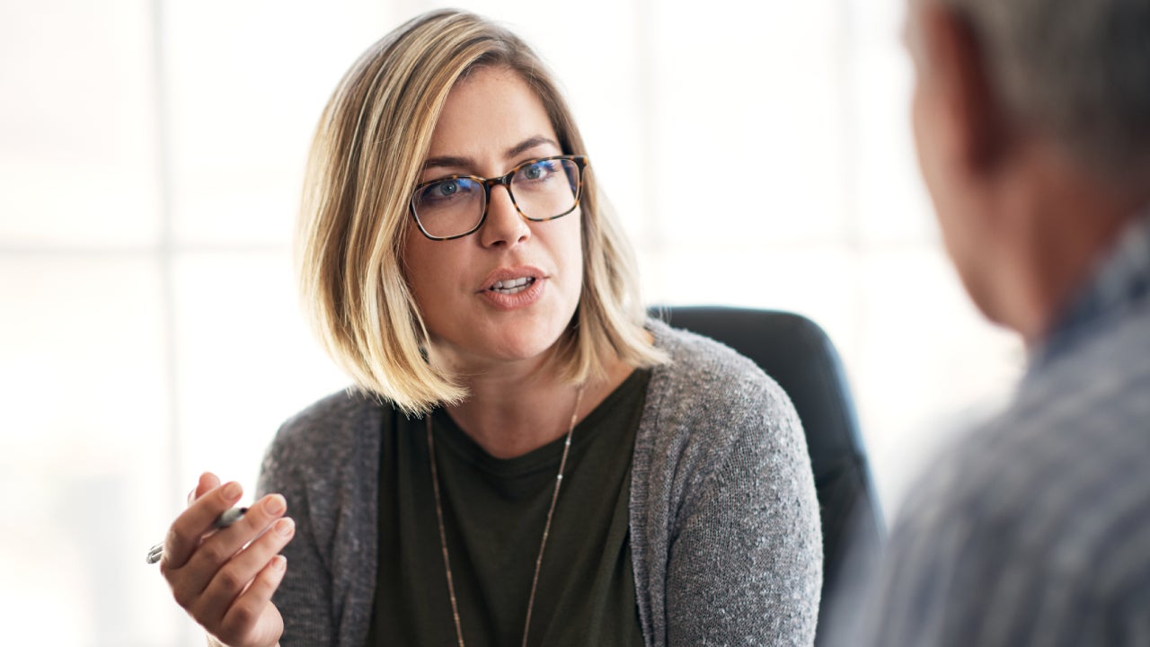 Shot of a young businesswoman having a discussion with her colleague in a modern office