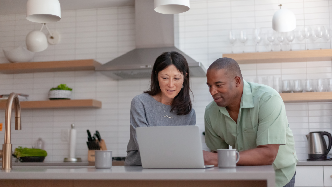 Couple use a laptop computer to pay bills online