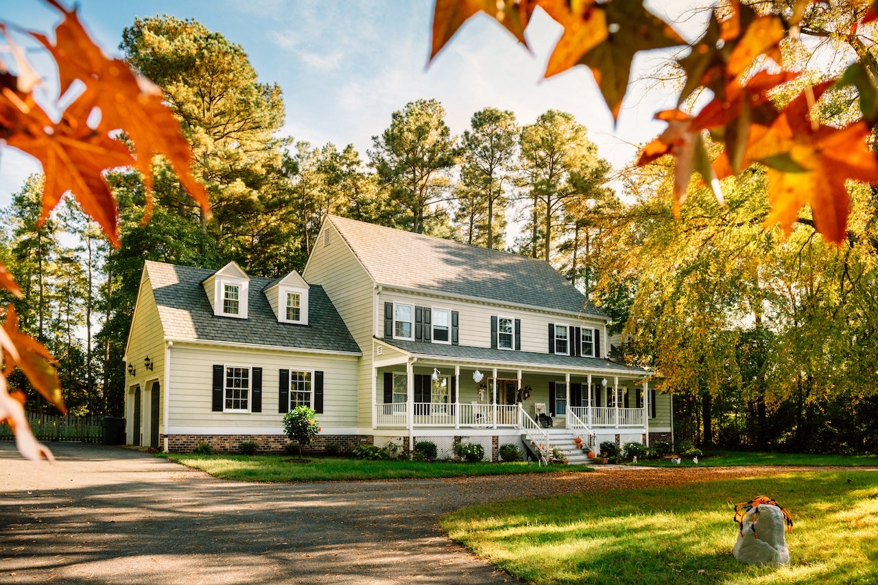 large colonial style house with front porch and 2 car garage