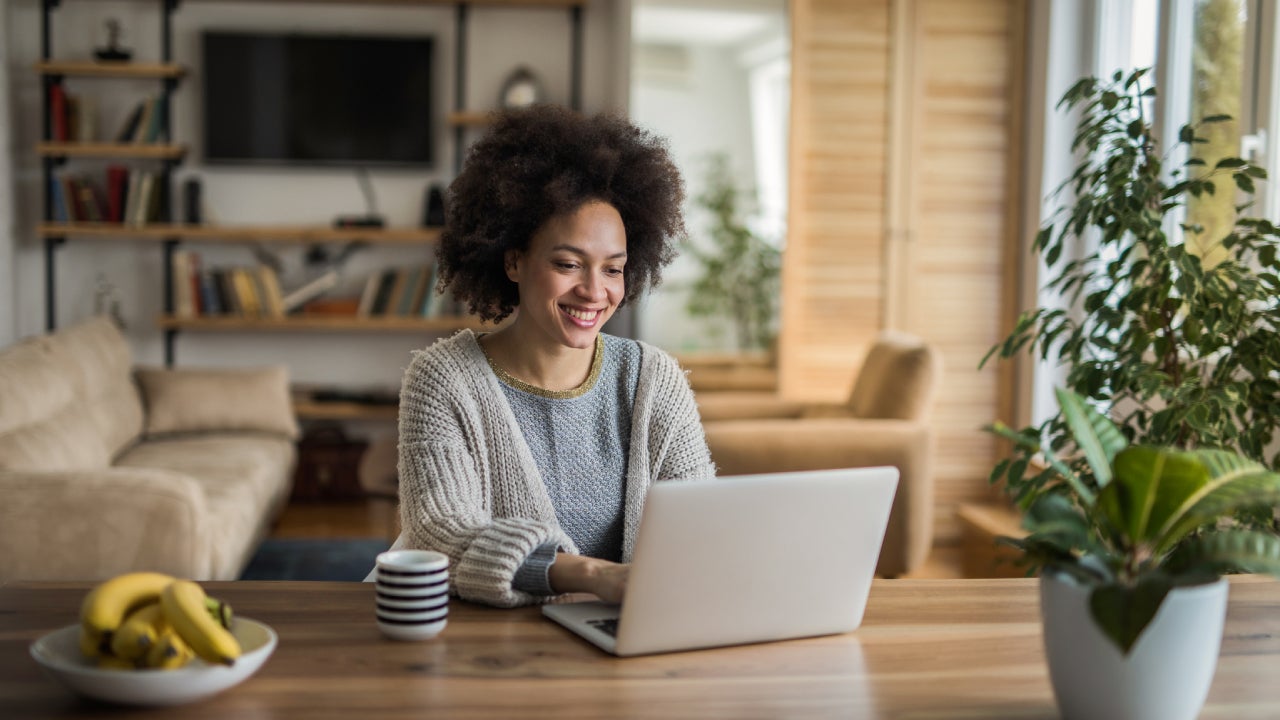 Woman at home doing online banking on a laptop