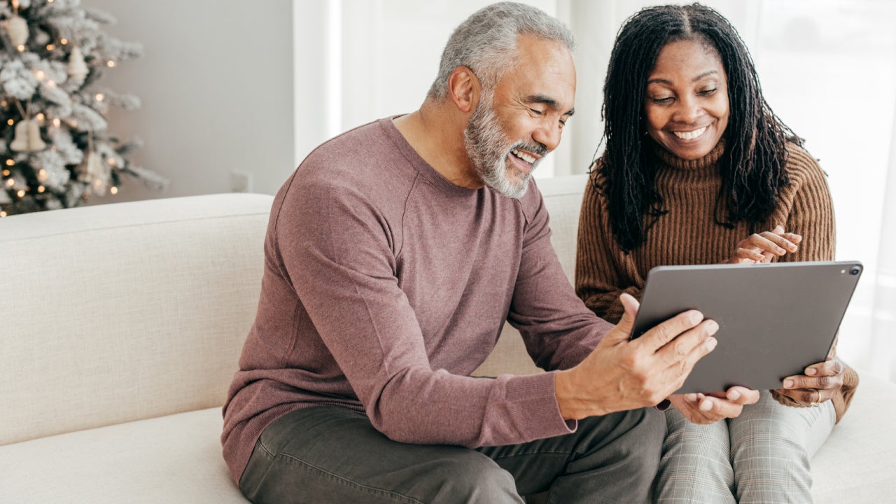 Senior women and senior men use a tablet during the Winter Holidays