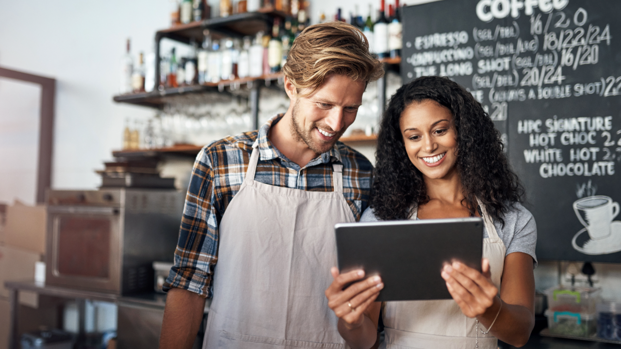 Two business partners review information on a tablet.