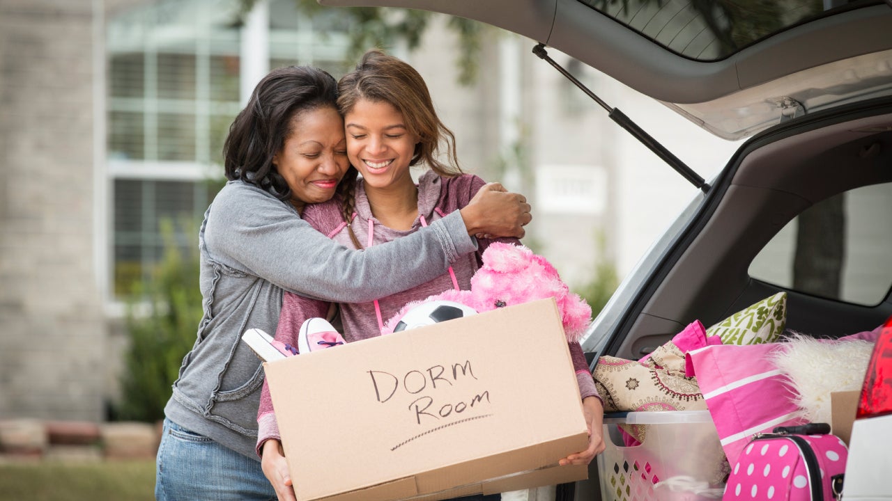 mother helping daughter pack for college