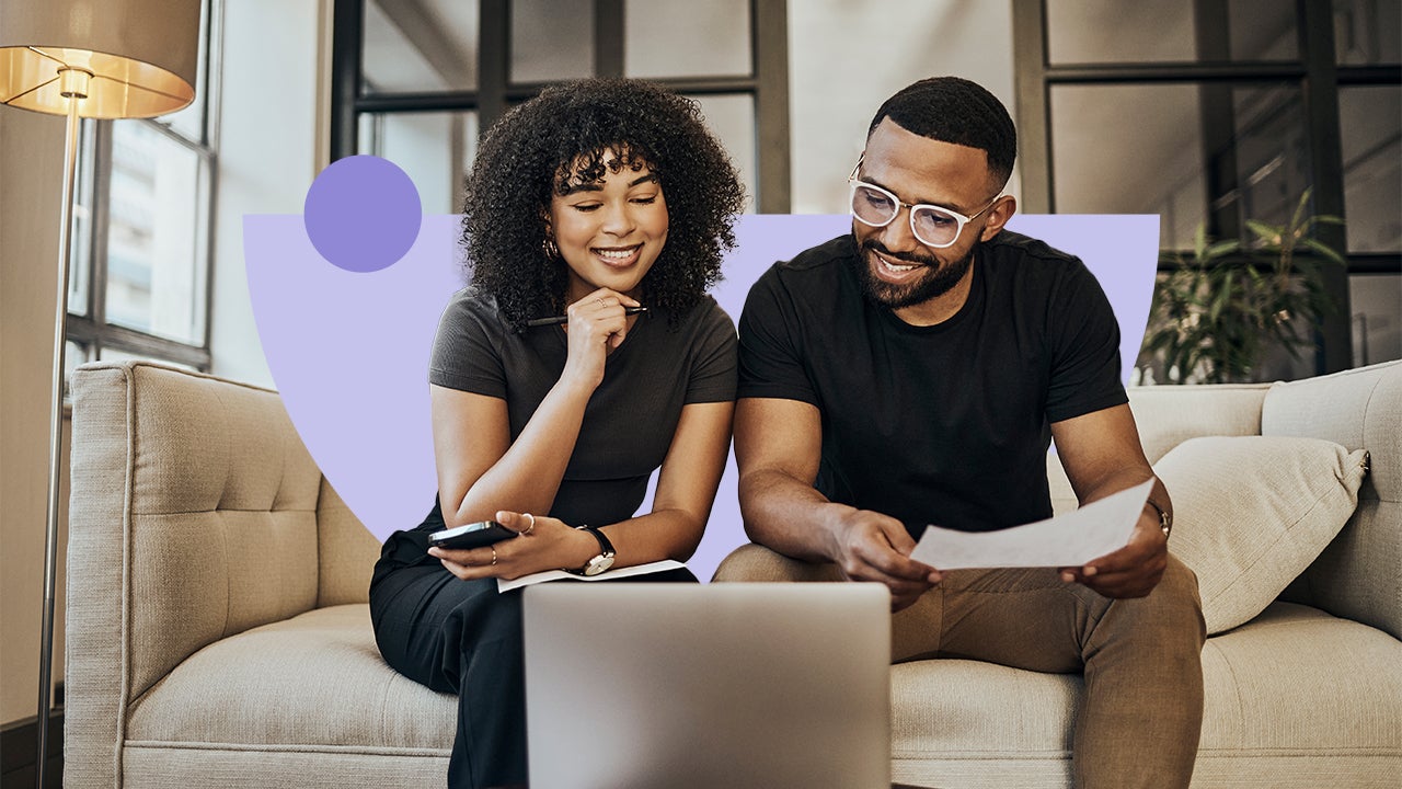 A couple reviewing their finances and sitting in front of a laptop