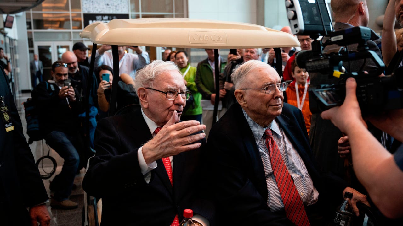 Warren Buffet speaking on a golf cart