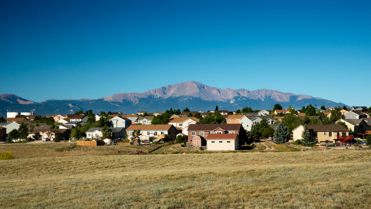 Pikes Peak, the highest summit of the southern Front Range of the Rocky Mountains, rises above a housing development in the fast growing suburbs of Colorado Springs, Colorado.