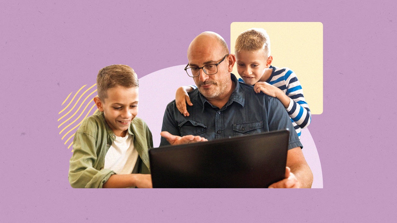 A parent sitting in front of a laptop with their kids